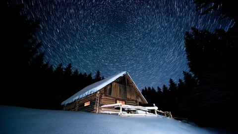Time-lapse. Star circles over wooden house in the winter forest Stock Footage 97221782