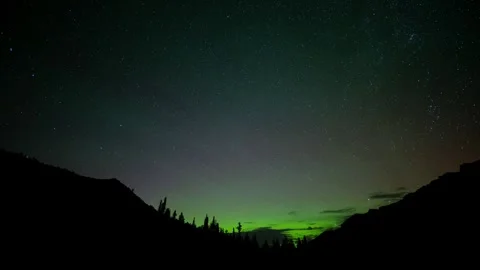 Time lapse of a star filled sky with green Aurora along the horizon  Stock Footage 250840710