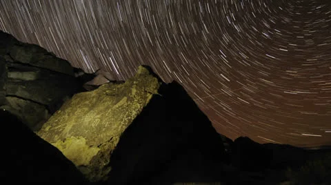 Time lapse star trail streaks over a sacred Owens Valley Paiute petroglyph site Видео 27188475