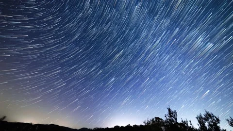 Time lapse of star trails, night sky in the Tuscan country, Italy. 4K Stock Footage