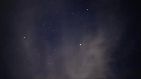 Time lapse of stars beyond clearing thin clouds in the night sky Stock Footage 260169810