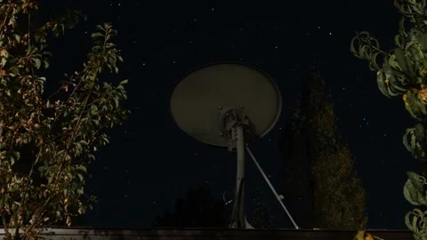 Time lapse of stars beyond a home satellite dish Stock Footage 286248071