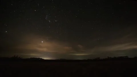 Time lapse of stars over thin clouds over a grassland prairie Stock Footage 321196428