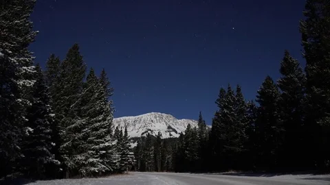 Time-lapse of stars rotating over snow covered mountains Stock Footage 73050020