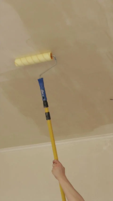 Time lapse stop motion of priming concrete ceiling with paint roller Stock Footage 340404960