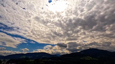 Time lapse of storm clouds and sun over hills Video stock 315411504