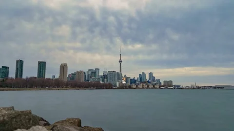 Time lapse of storm clouds catching soft light over the Toronto skyline Stock Footage 224559357