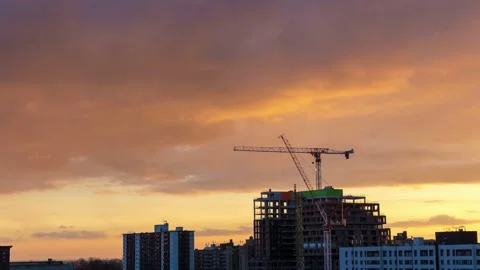 Time lapse of storm clouds catching vibrant golden light at sunset over a crane Stock Footage 238848032