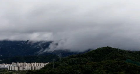 Time lapse of storm clouds changing and moving fast over mountains Stock Footage 96020869