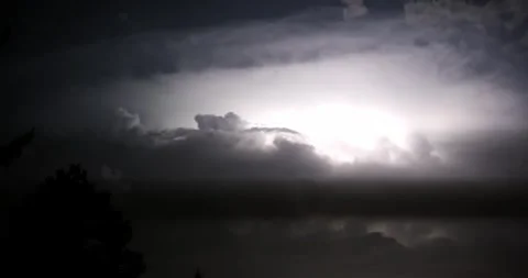 Time lapse of storm clouds with frequent lightning strikes above dark clouds Stock Footage 345026692