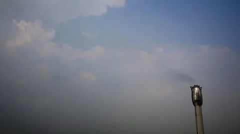 Time lapse of storm clouds moving fast behind chimney of incineration plant Stock Footage 65846079