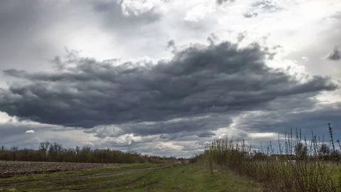 Time lapse storm clouds moving over the field Stock Footage 74345384