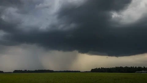 Time lapse of storm clouds moving over farmland grassland farming meadow field Stock Footage 136406802