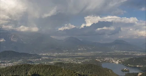 Time lapse of storm clouds moving above lake Bled Stock Footage 166879393