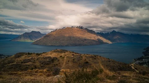 Time lapse of storm clouds over mountain peaks at Lake Wakatipu in New Zealand Stock Footage 120732391