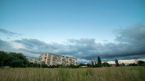 Time lapse storm clouds pass over residential buildings, the outskirts of the Stock Footage 112957093