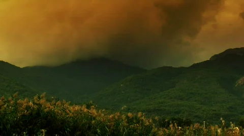 Time-lapse storm clouds rising over mountain Stock Footage 309453