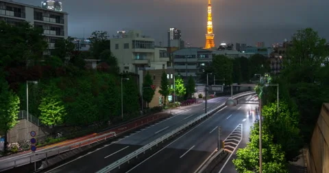 Time lapse as storm clouds roll in past Tokyo Tower tilt and zoom Stock Footage 49361520