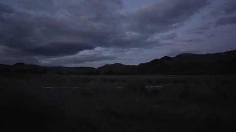 Time lapse of storm clouds rolling over hills at dusk in Oregon Stock Footage 346794748
