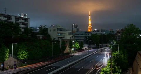 Time lapse of storm clouds as they roll in past illuminated Tokyo Tower Stock Footage 49361510