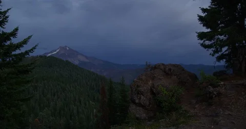 Time-lapse of storm over Mt. Jefferson suddenly giving way to sun beam Stock Footage 127779873
