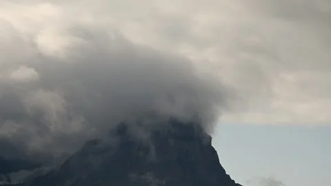 Time lapse of storm snow clouds blowing across a rugged rocky mountain Stock Footage 296657182
