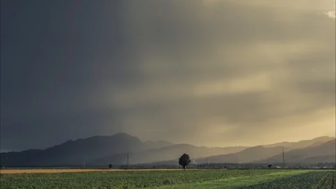 Time lapse storm yellow sun rays shine through clouds Stock Footage 120990425