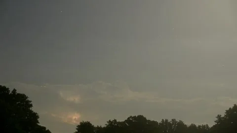 Time lapse of storms clouds above trees, with full moon rising and lighting up t Stock Footage 289554127