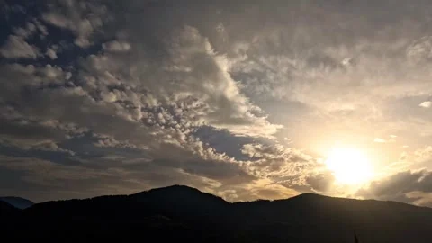 Time lapse of stormy clouds over mountain sunset Stock Footage 315783783