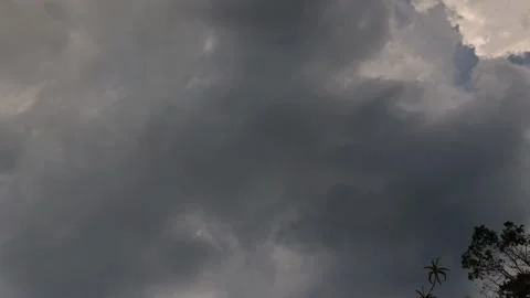 Time lapse of stormy dense clouds gathering and passing over the forest and f Stock Footage 274681218
