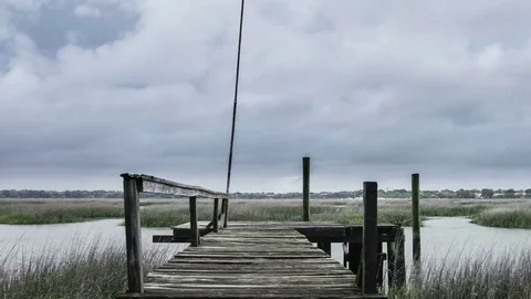 Time lapse of stormy sky over dock and marsh in Beaufort, South Carolina Stock Footage 72411036