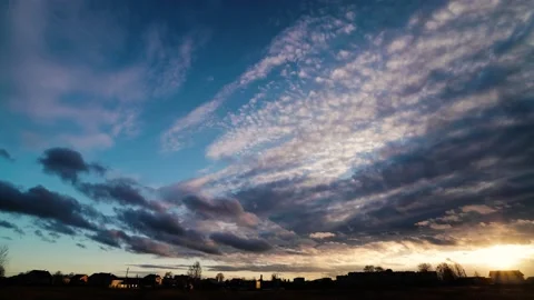Time lapse of strong movement from the wind of dark clouds across the sky on a 動画素材 146473453