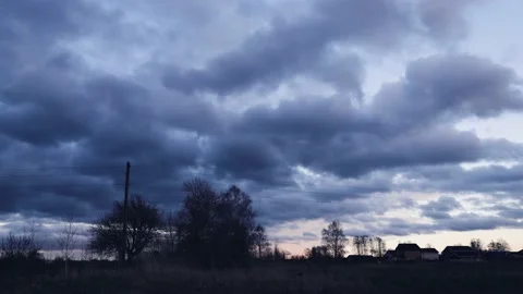 Time lapse of strong movement from the wind of dark clouds across the sky on a 動画素材 146474136