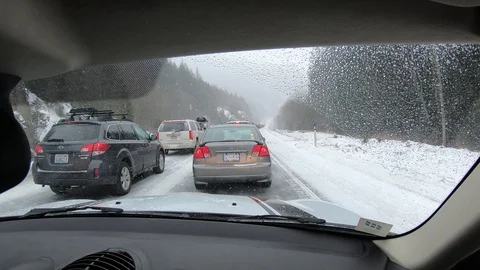 Time lapse stuck in slow traffic driving on snowy highway road. Stock Footage 102351900