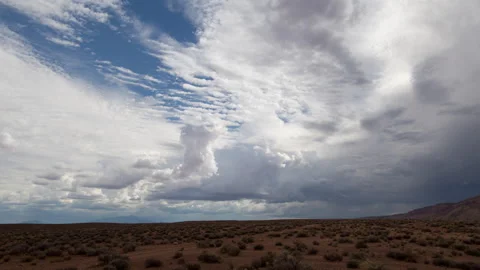 Time lapse of summer rain clouds forming in blue sky above open Arizona desert Stock Footage 158455226