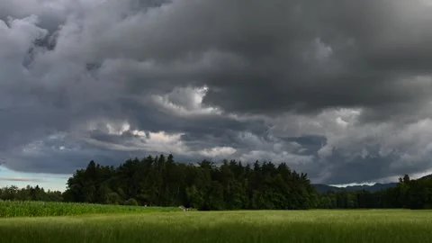 Time lapse of summer storm clouds forming over farming field Stock Footage 135604873