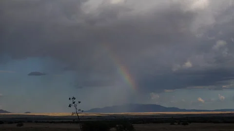 Time lapse of a summer storm with sun rays and a rainbow Stock Footage 247207549