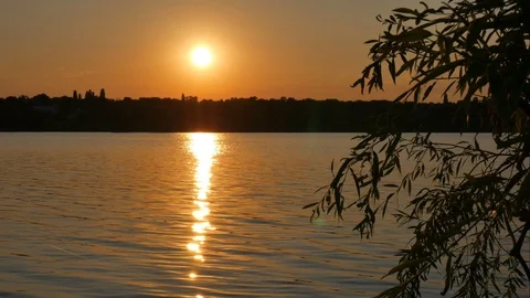 Time lapse of summer sunset against the background of a calm river Video stock 119888364