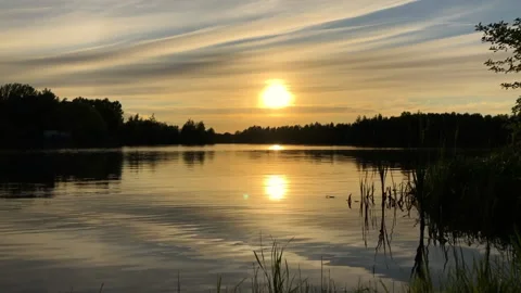 Time lapse summer sunset at lake with ripples on water surface Stock Footage 154830153
