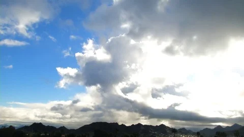 Time lapse of sun bursting through storm clouds over mountains in Arizona Stock Footage 72987521
