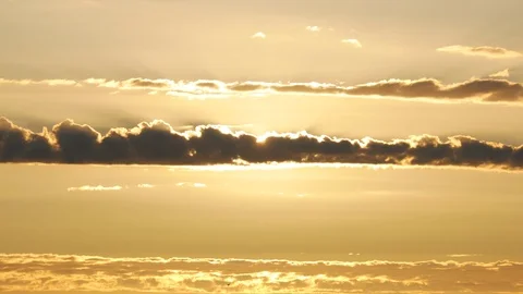 Time lapse sun emerging from behind flat clouds at sunset Stock Footage 111403306