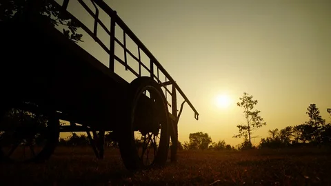Time lapse of sun going up behind wheelbarrow. 4K UHD Stock Footage 91675094