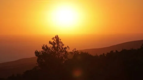 Time lapse of a sun going down into the water, view from the mountain. Stock Footage 199661371