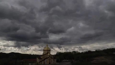 Time lapse: the sun hidden behind fluffy clouds flying in the sky. Stock Footage 136821554