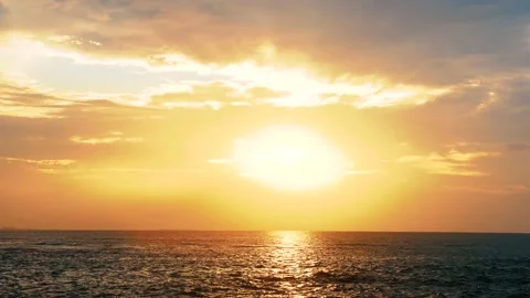 Time lapse Sun light Flare appear from cloud and back again before sunset on sea Stock Footage 153590849