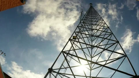 Time Lapse of sun moving through a microwave tower as clouds move by. Stock Footage 40504995