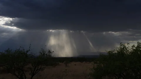 Time lapse of sun rays and rain in a desert storm Stock Footage 246628129