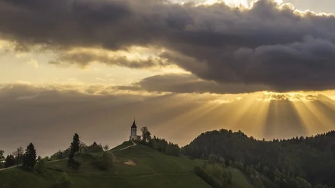 Time lapse sun rays emerging through dark clouds Stock Footage 120990014