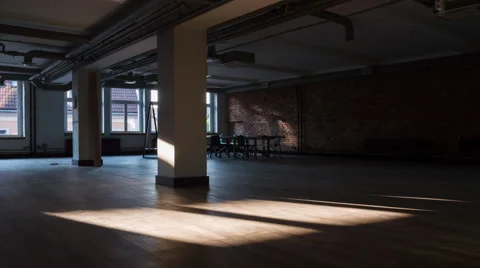 Time-lapse of sun rays moving over an empty rustic office space Stock Footage