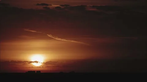 Time lapse of The sun rises over the forest against the orange sky Video stock 138797400